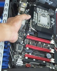 Hand put mainboard with CPU into ATX computer case with cable